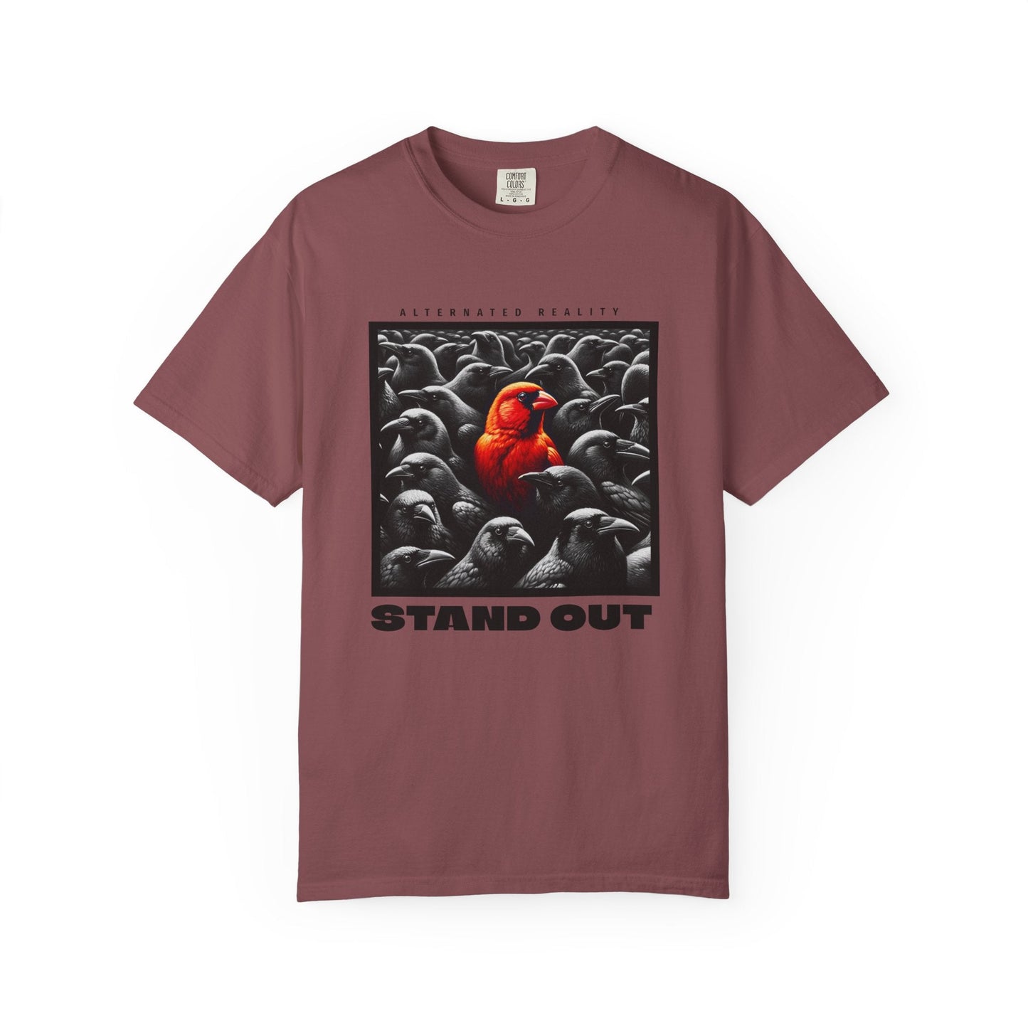 Garment-dyed muted orange t-shirt with artistic bird graphic and "STAND OUT" text