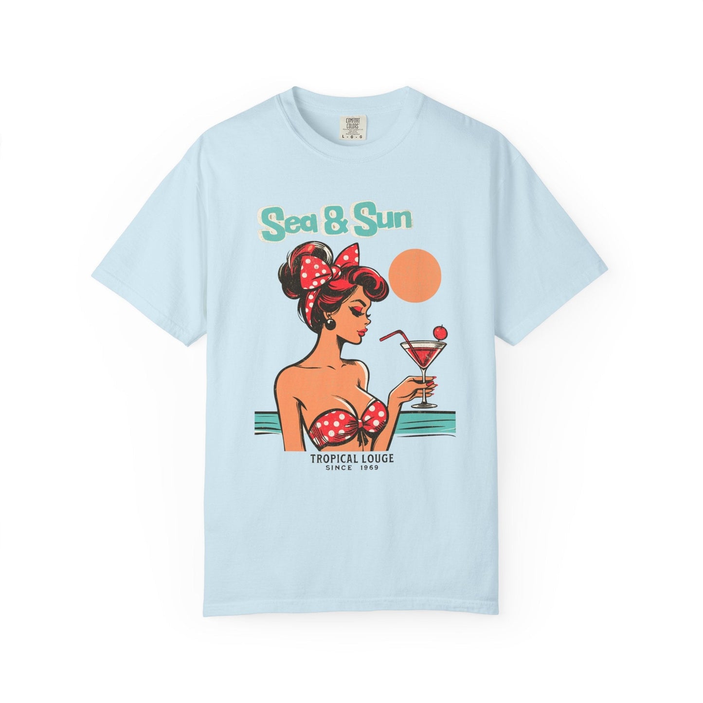 Light blue t-shirt with vintage pin up red-haired woman holding cocktail and "Sea & Sun Tropical Lounge" text.