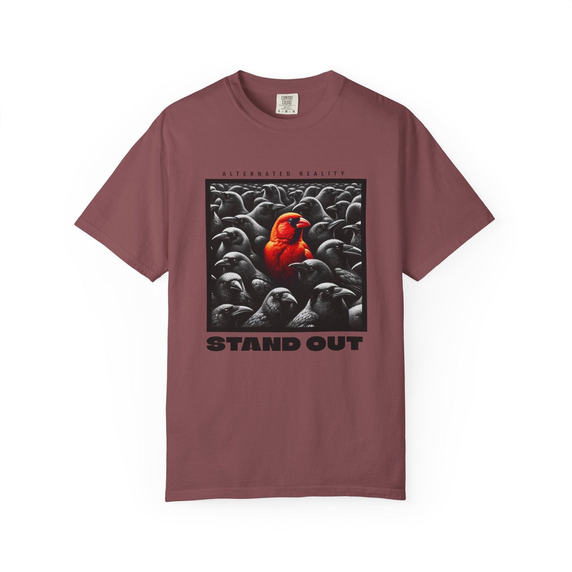 Garment-dyed muted orange t-shirt with artistic bird graphic and "STAND OUT" text